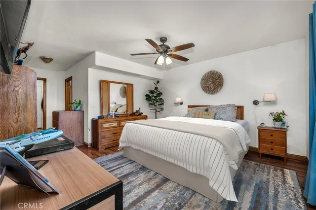 a bedroom with bed and wooden floor