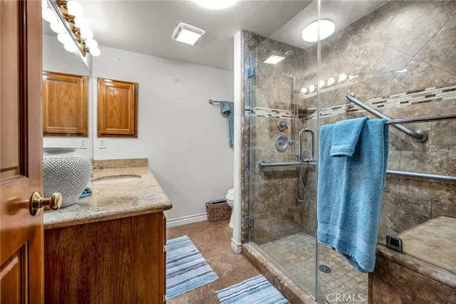 a bathroom with double vanity and a shower