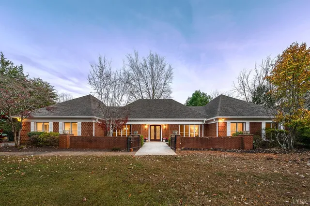 a front view of a house with yard porch and tree
