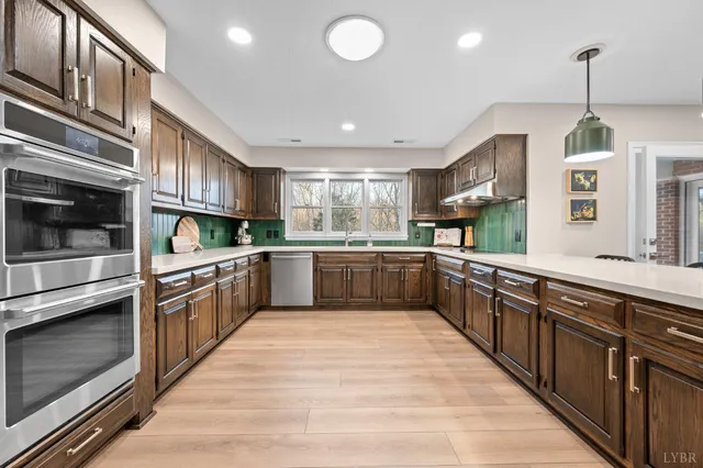 a kitchen with stainless steel appliances granite countertop a refrigerator oven and cabinets