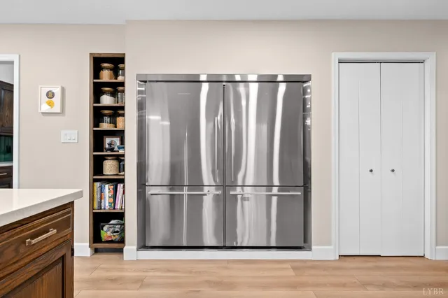 a spacious bedroom with two beds and a window