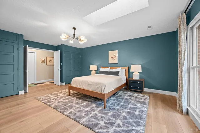 a bedroom with bed and a chandelier