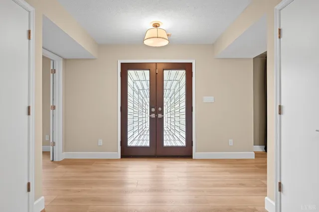 a living room with furniture large window and flat screen tv