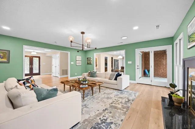 a kitchen with stainless steel appliances kitchen island granite countertop a table chairs and a refrigerator