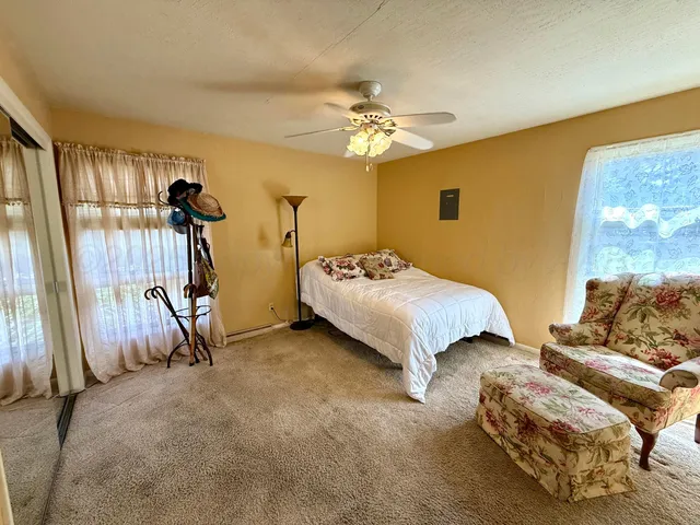 a bedroom with bed and a window