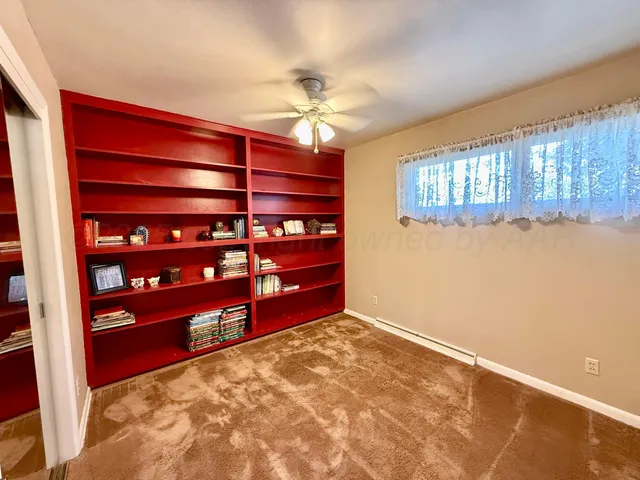 a view of a room with window and cabinet