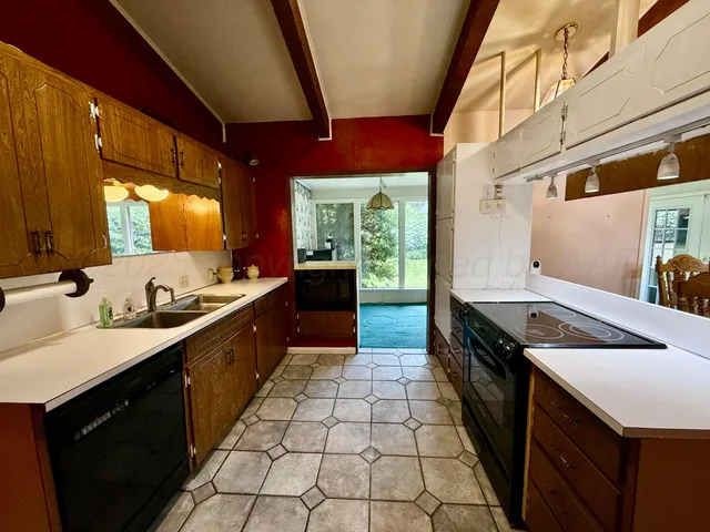 a kitchen with stainless steel appliances granite countertop a sink and a stove