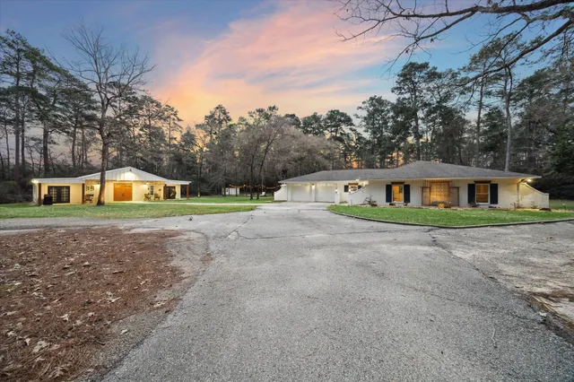 a front view of house with outdoor space and trees around