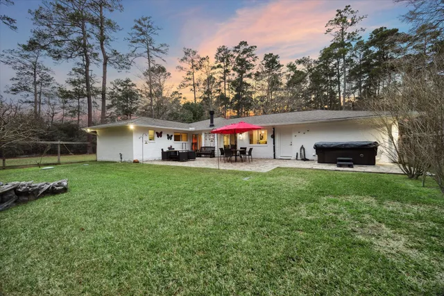 a view of a house with a yard and tree s