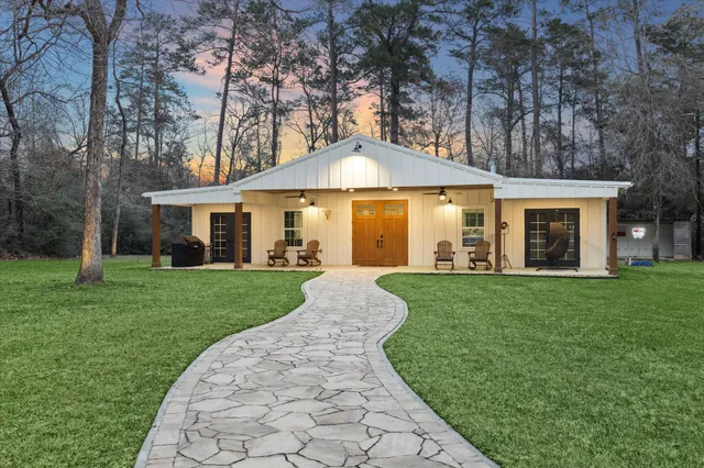 a view of a patio with table and chairs under an umbrella