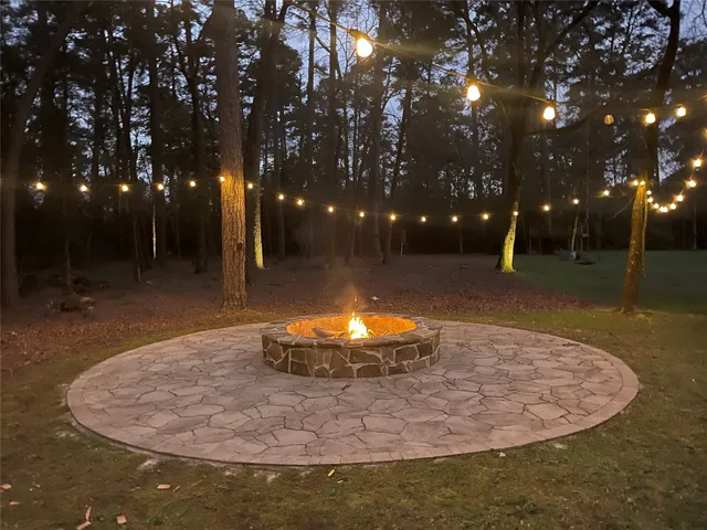 a view of a green field with trees in the background