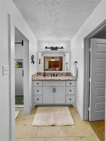 a spacious bathroom with a sink and a mirror