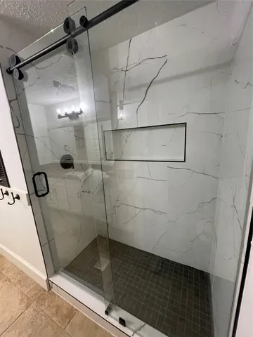 a bathroom with a glass shower door