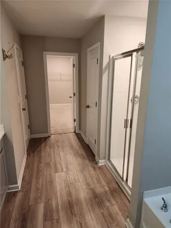 a view of front door with wooden floor and a glass door