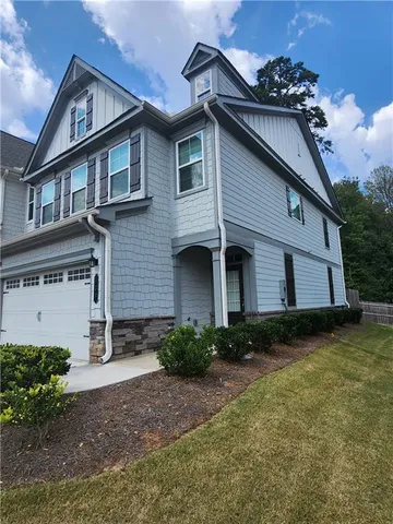 a front view of a house with garden