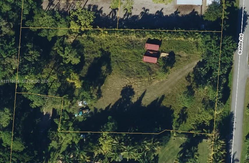 an aerial view of a house with a yard