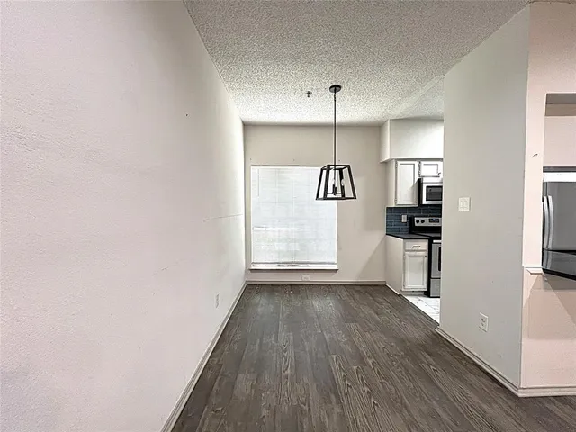 a view of kitchen with cabinets and wooden floor