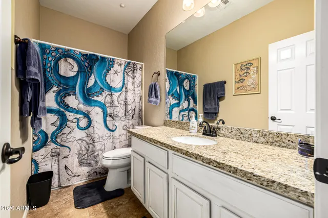 a living room with furniture a rug and a book shelf