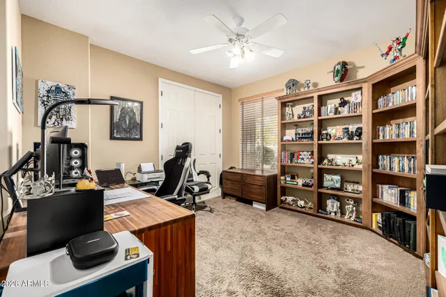 a view of a workspace with bookshelf and a workspace
