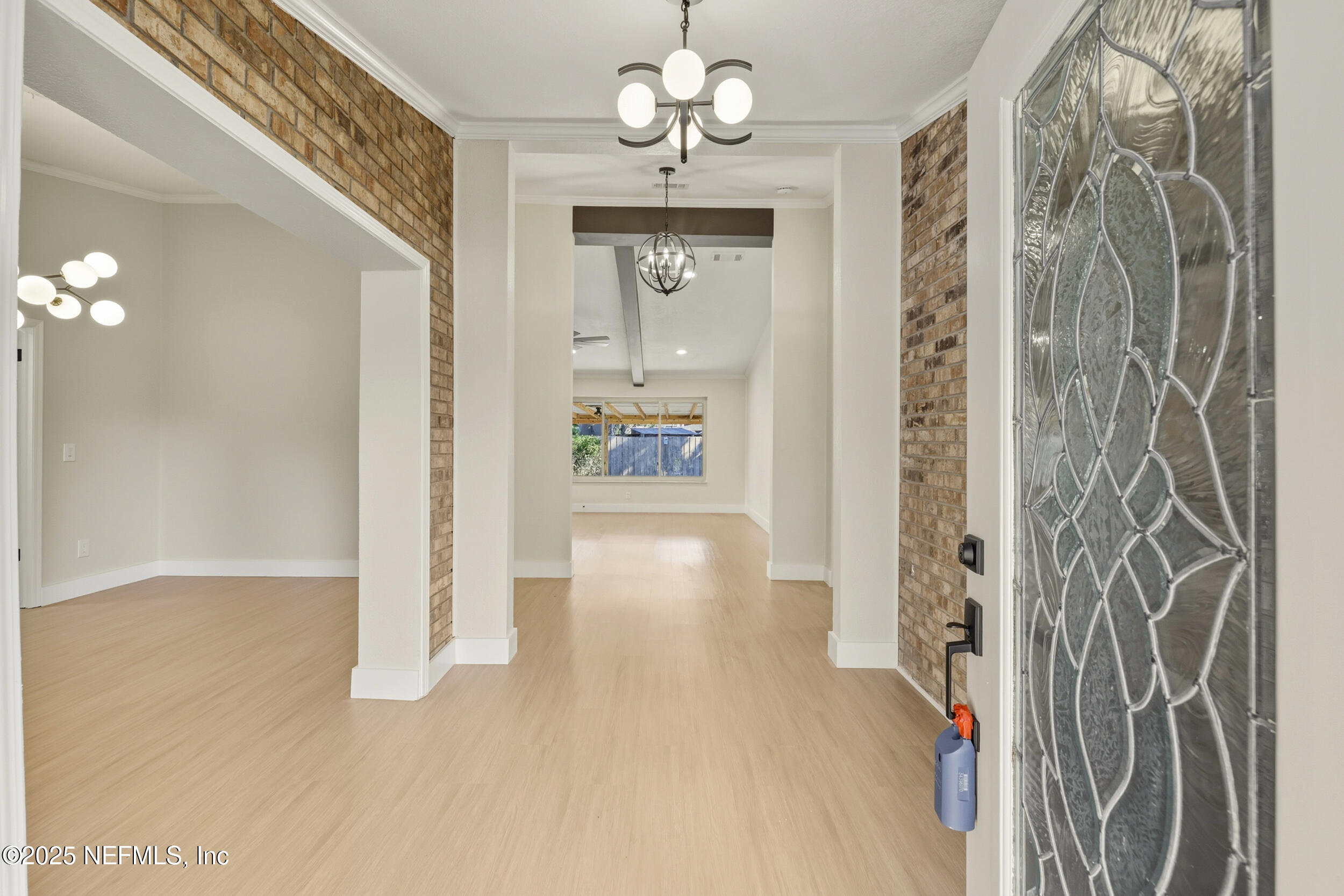 11455 Scott Mill Road Jacksonville, FL 32223 - Photo 15 of 46 a view of a hallway with wooden floor and a chandelier