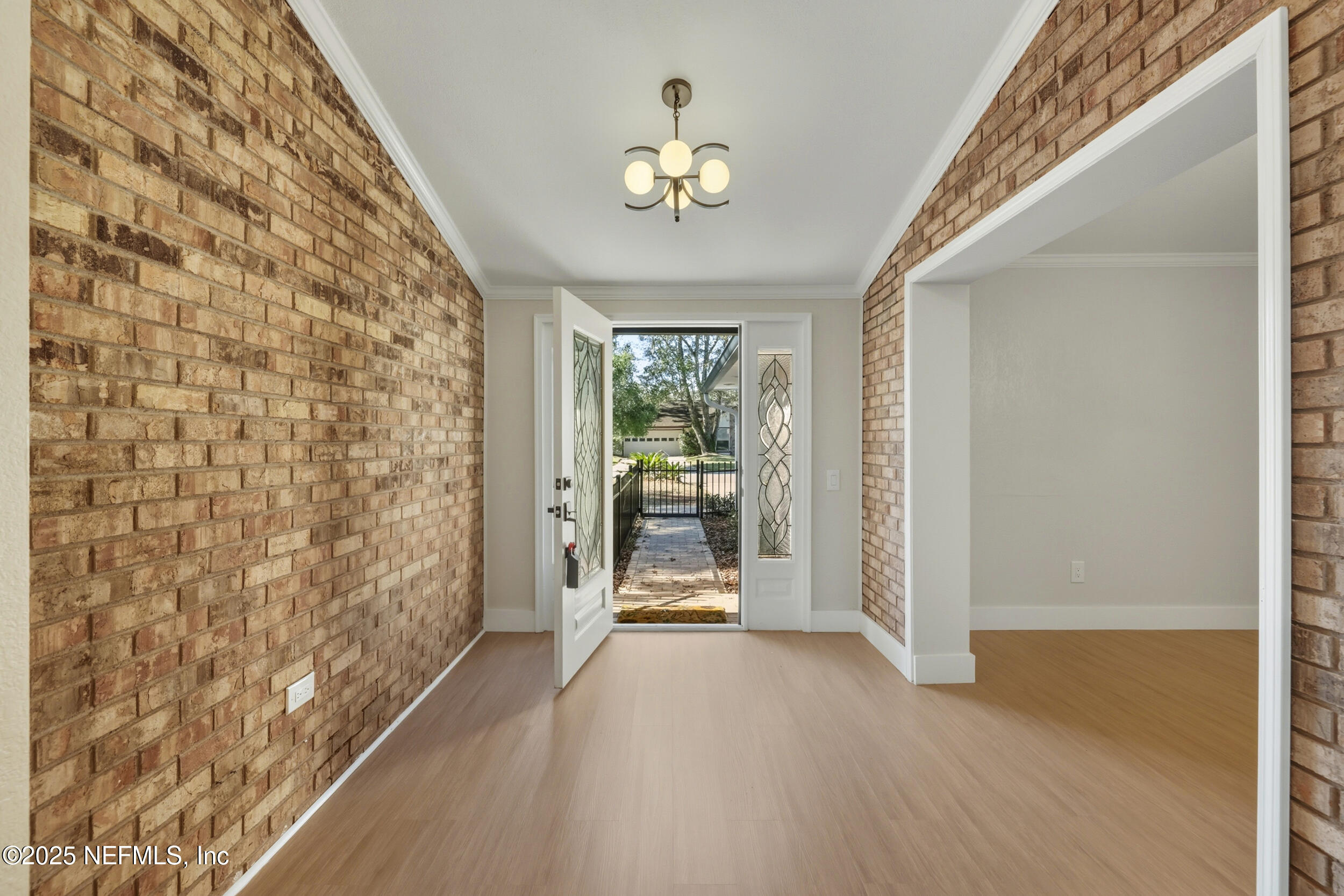 11455 Scott Mill Road Jacksonville, FL 32223 - Photo 17 of 46 a view of a hallway with wooden floor and a dining room
