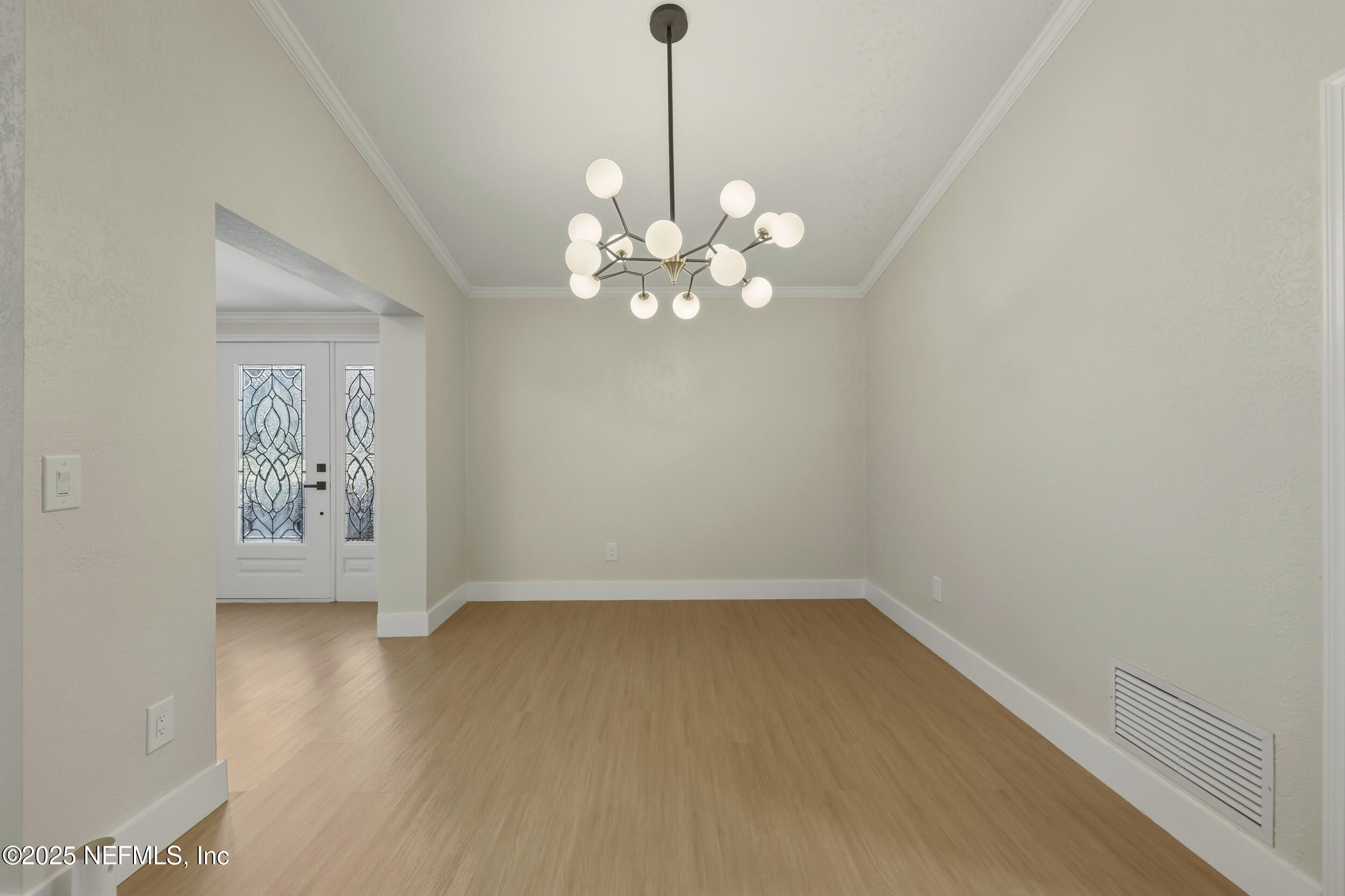 11455 Scott Mill Road Jacksonville, FL 32223 - Photo 18 of 46 a view of an empty room with chandelier fan