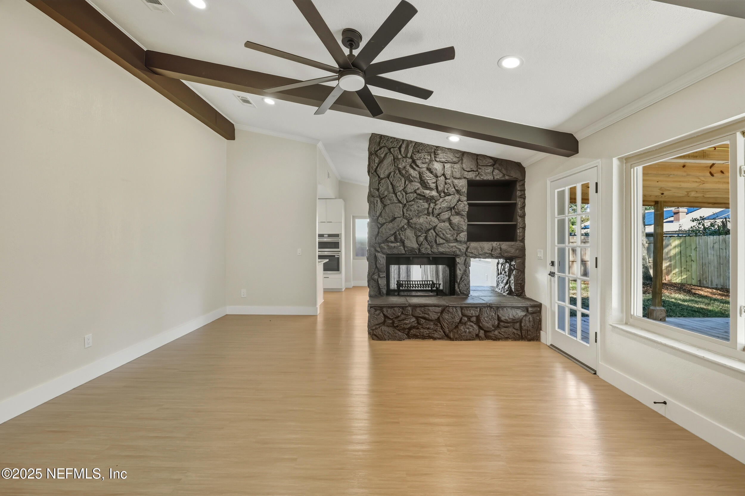 11455 Scott Mill Road Jacksonville, FL 32223 - Photo 20 of 46 a view of an empty room with a fireplace and a window