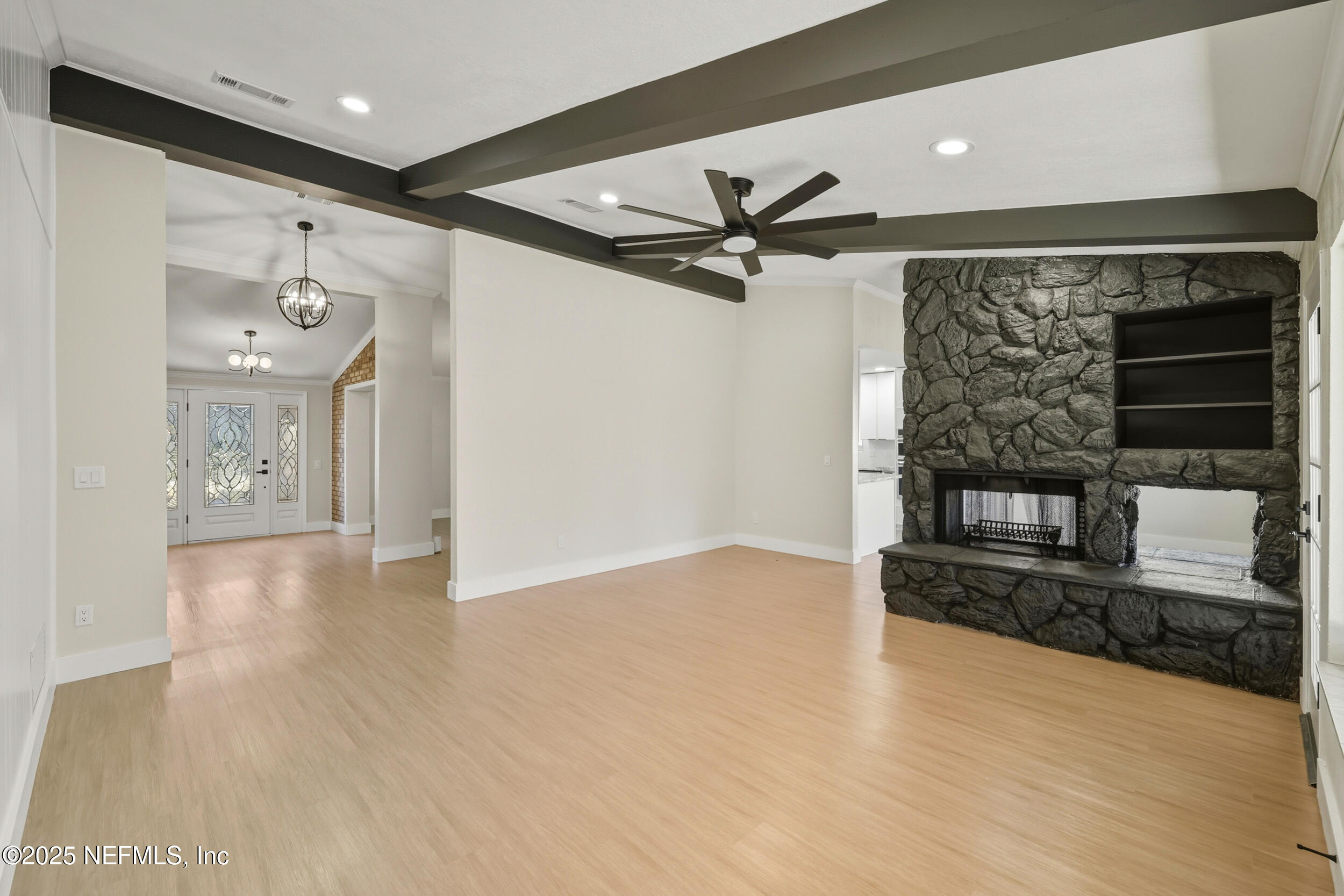 11455 Scott Mill Road Jacksonville, FL 32223 - Photo 21 of 46 a view of a livingroom with wooden floor and a ceiling fan