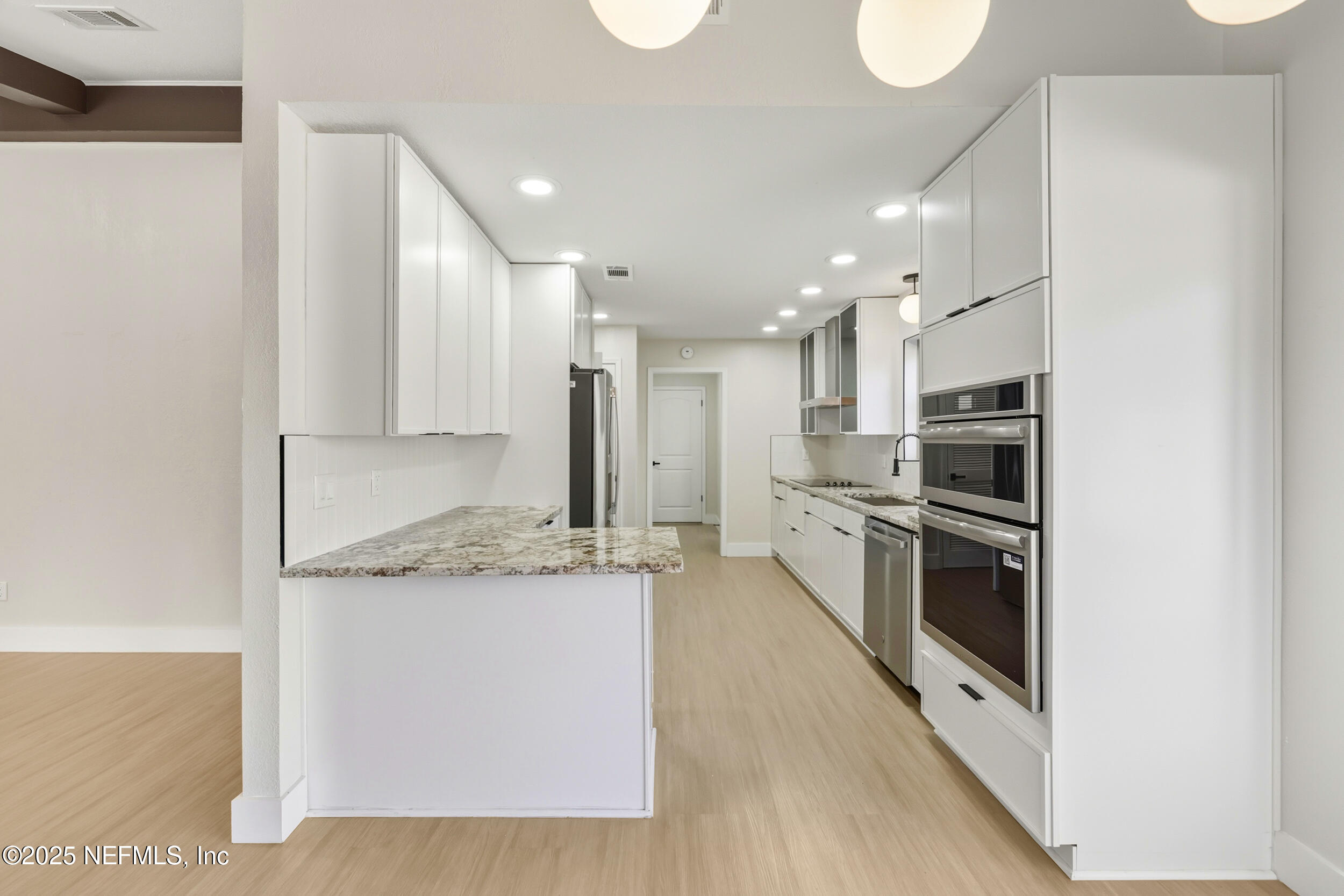11455 Scott Mill Road Jacksonville, FL 32223 - Photo 26 of 46 a kitchen with stainless steel appliances granite countertop a stove a sink and a refrigerator