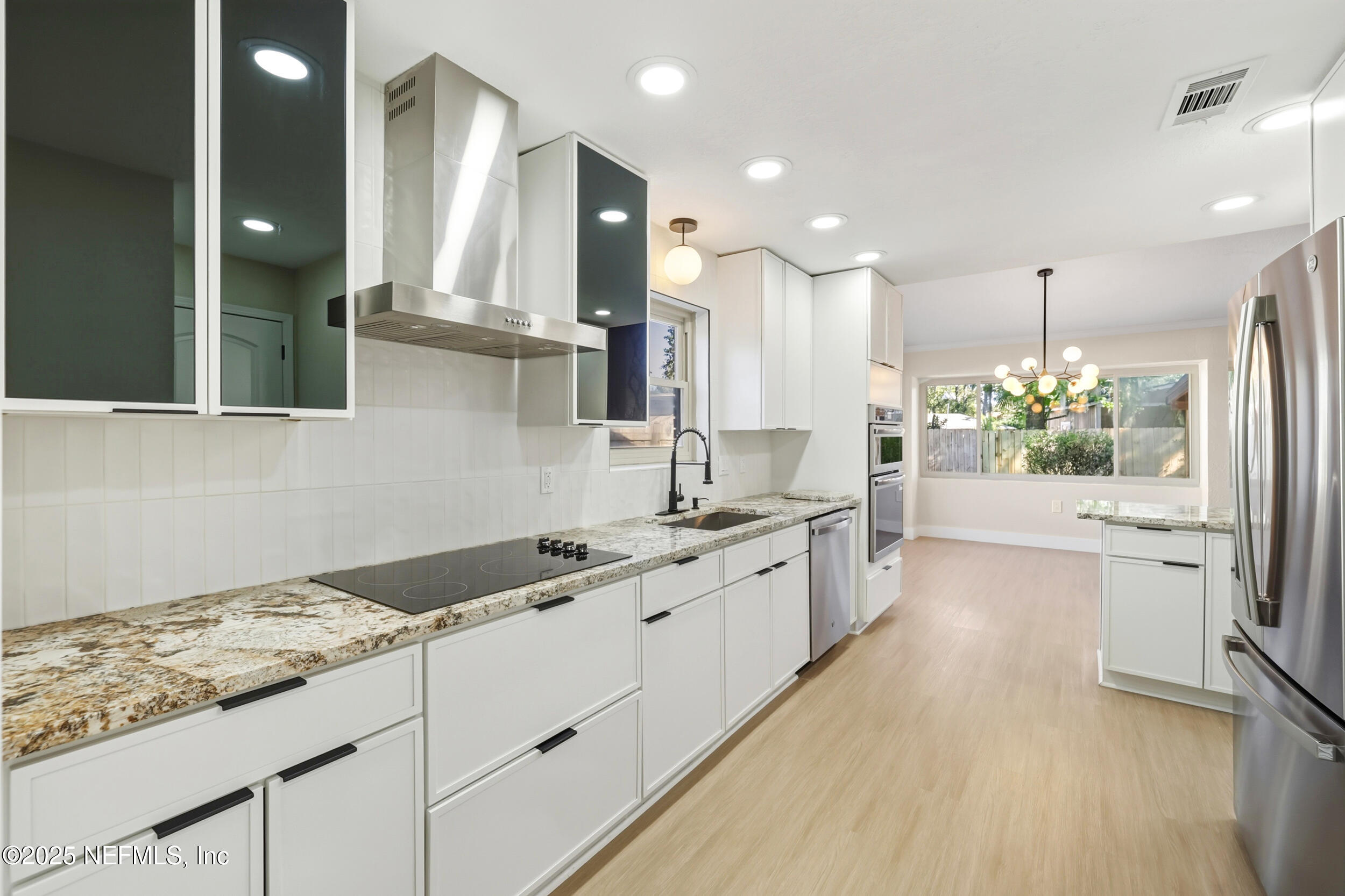 11455 Scott Mill Road Jacksonville, FL 32223 - Photo 29 of 46 a large kitchen with granite countertop a sink stove and refrigerator