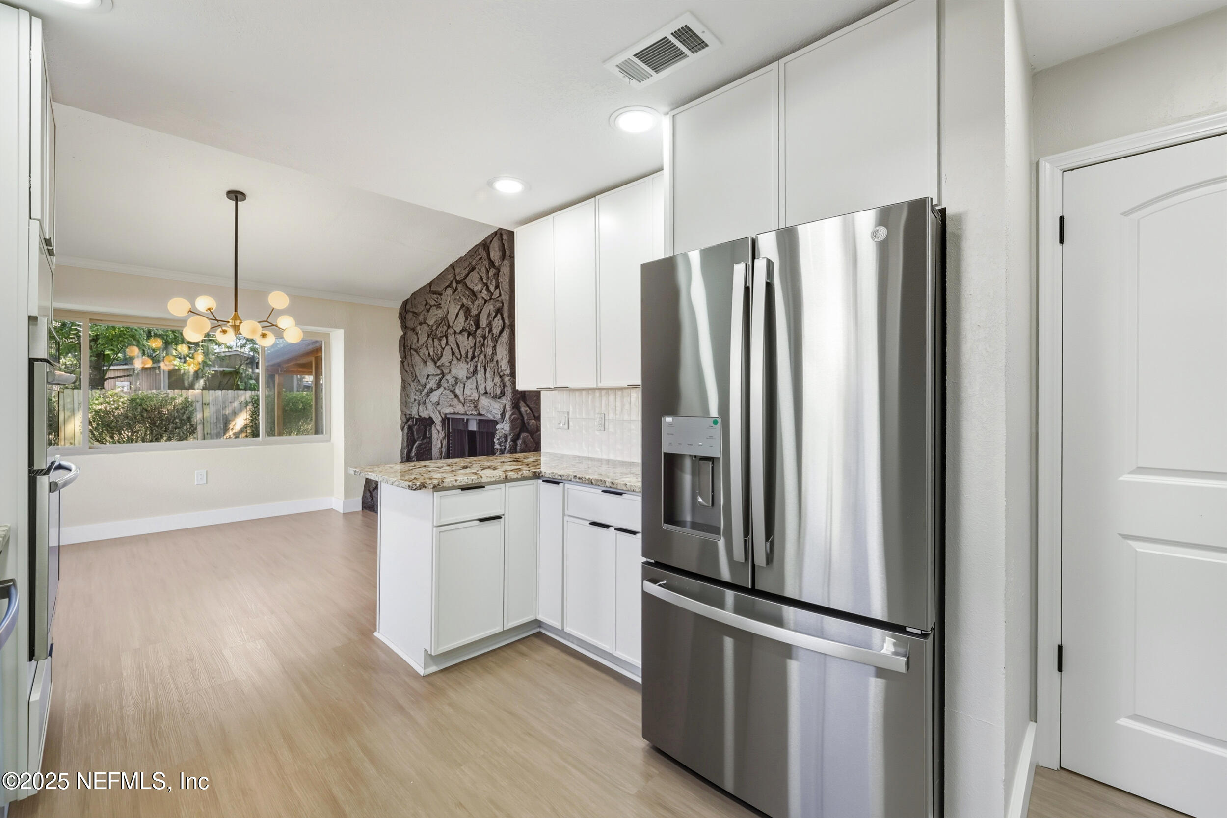 11455 Scott Mill Road Jacksonville, FL 32223 - Photo 31 of 46 a kitchen with stainless steel appliances a refrigerator and wooden floor