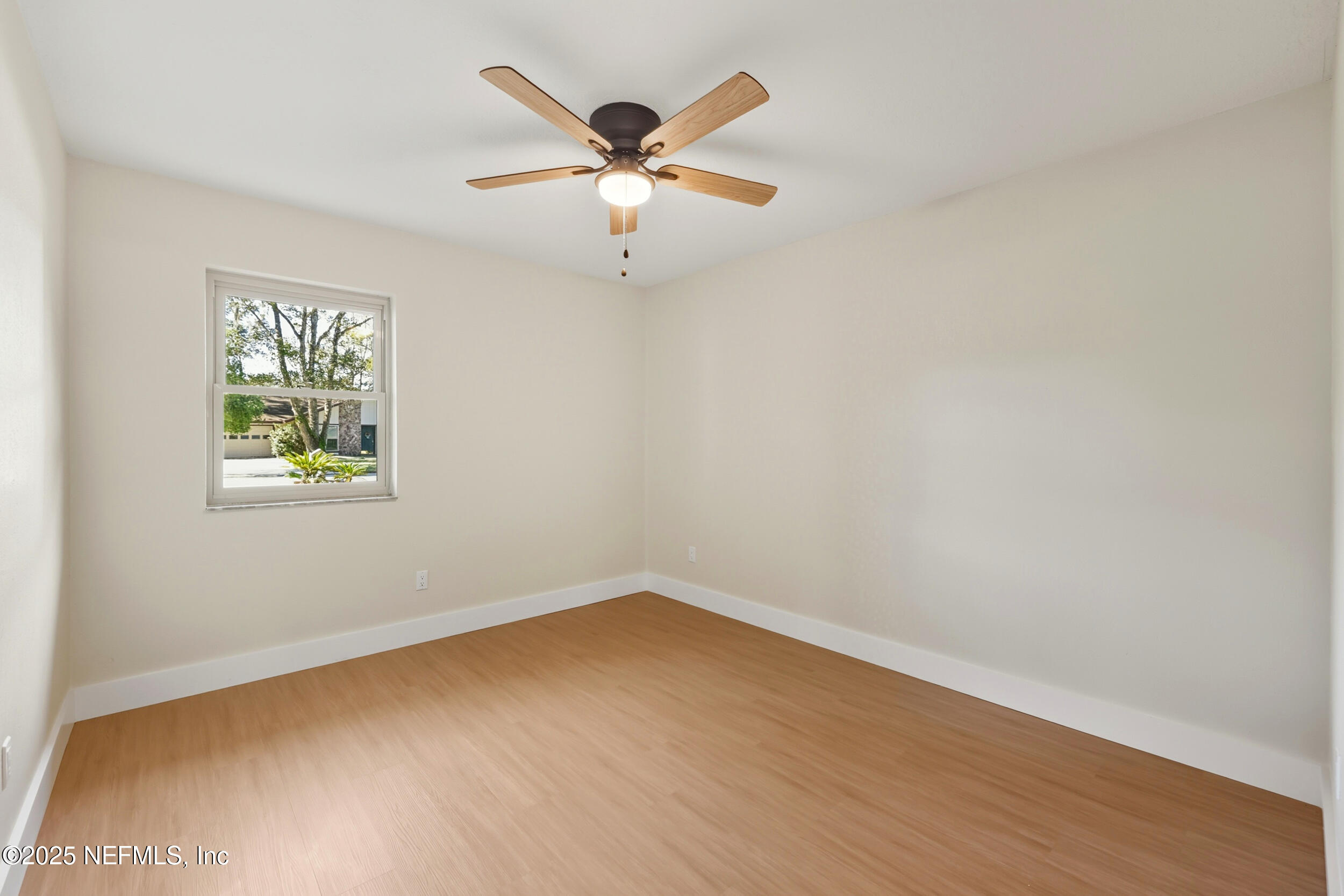 11455 Scott Mill Road Jacksonville, FL 32223 - Photo 32 of 46 an empty room with a window and ceiling fan