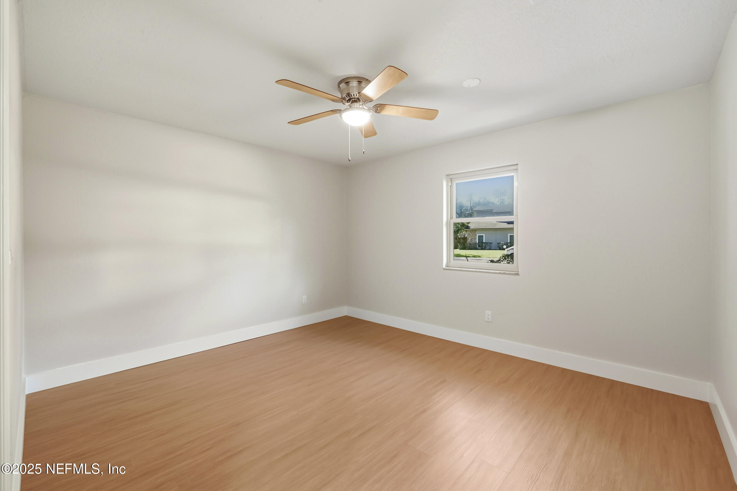 11455 Scott Mill Road Jacksonville, FL 32223 - Photo 36 of 46 an empty room with a window and a fan