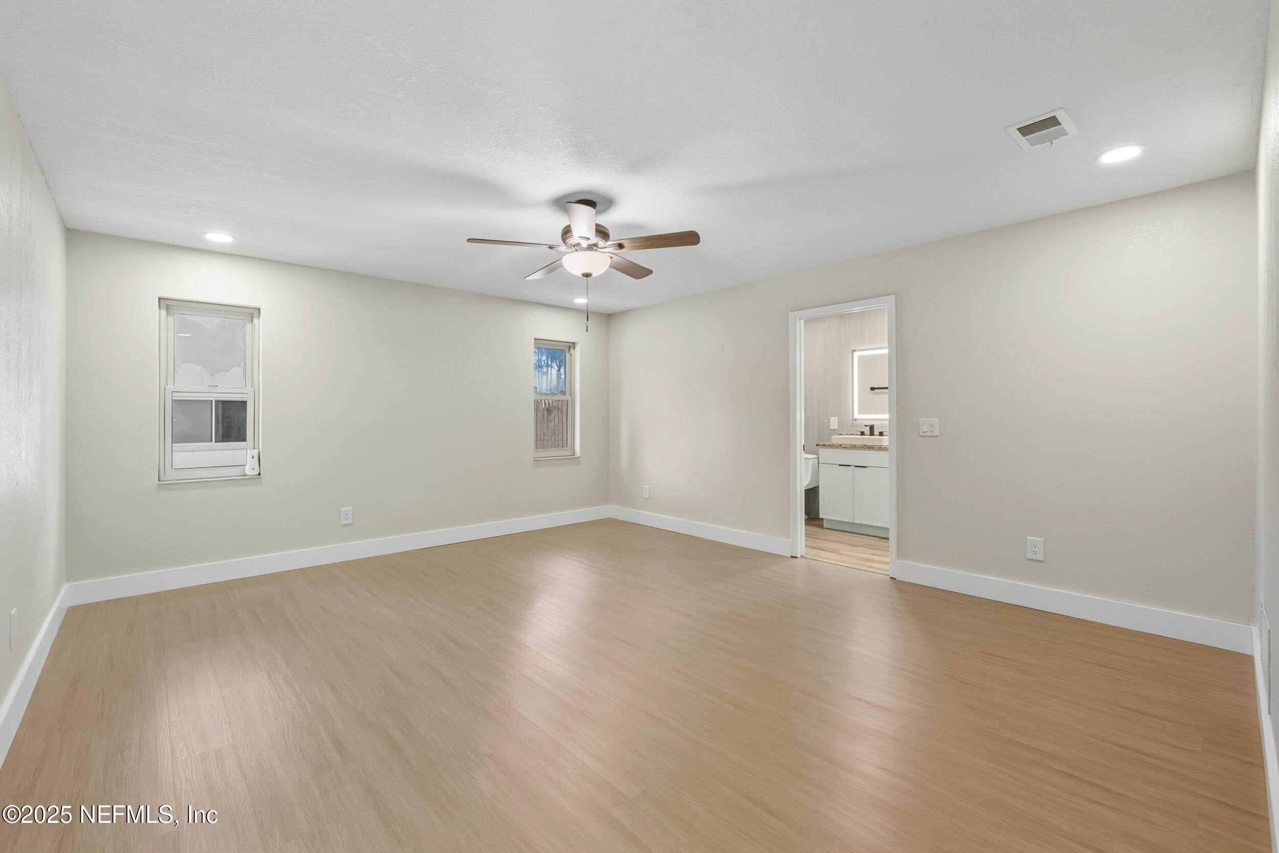 11455 Scott Mill Road Jacksonville, FL 32223 - Photo 37 of 46 a view of an empty room with a window and wooden floor