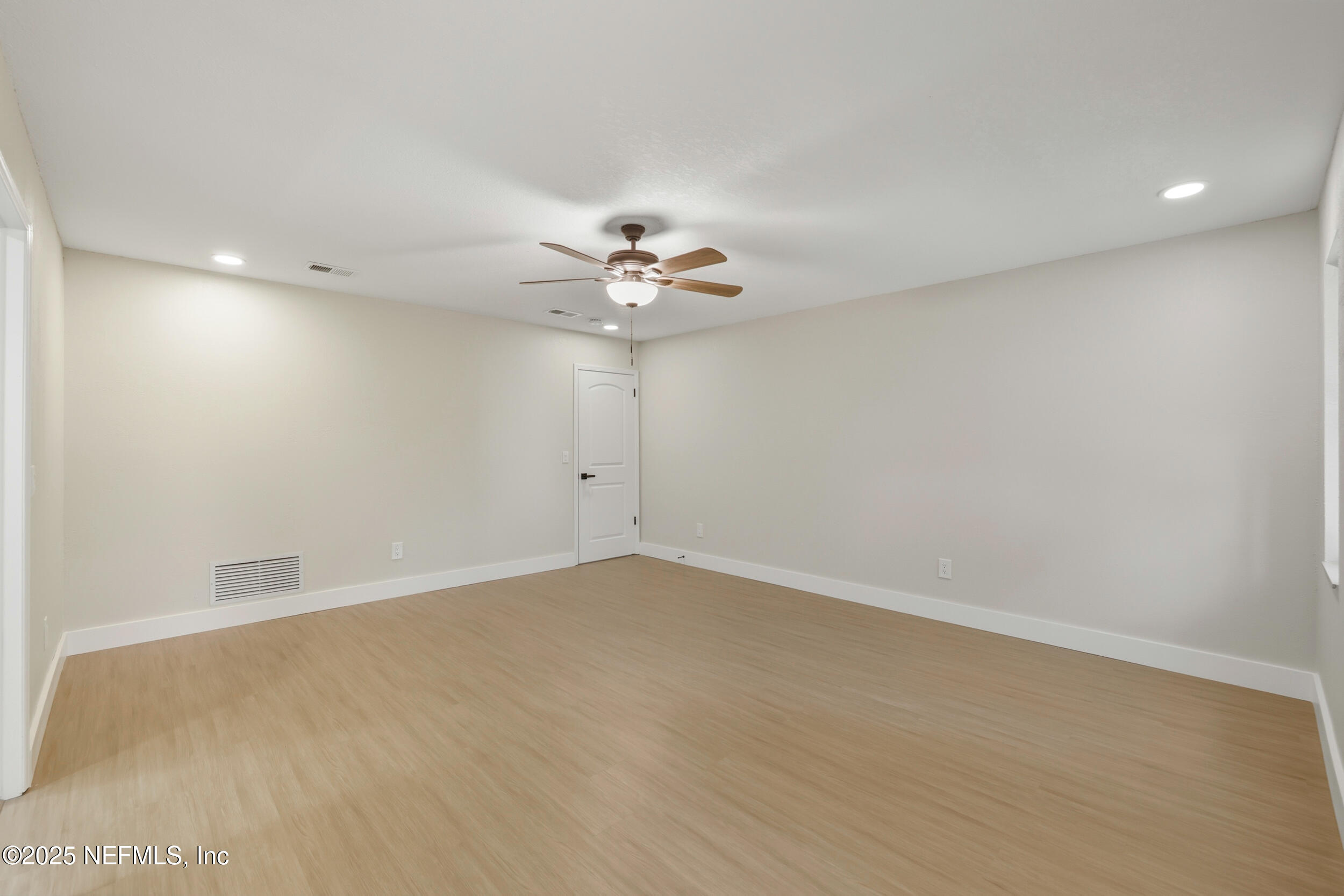 11455 Scott Mill Road Jacksonville, FL 32223 - Photo 38 of 46 an empty room with a ceiling fan and a window