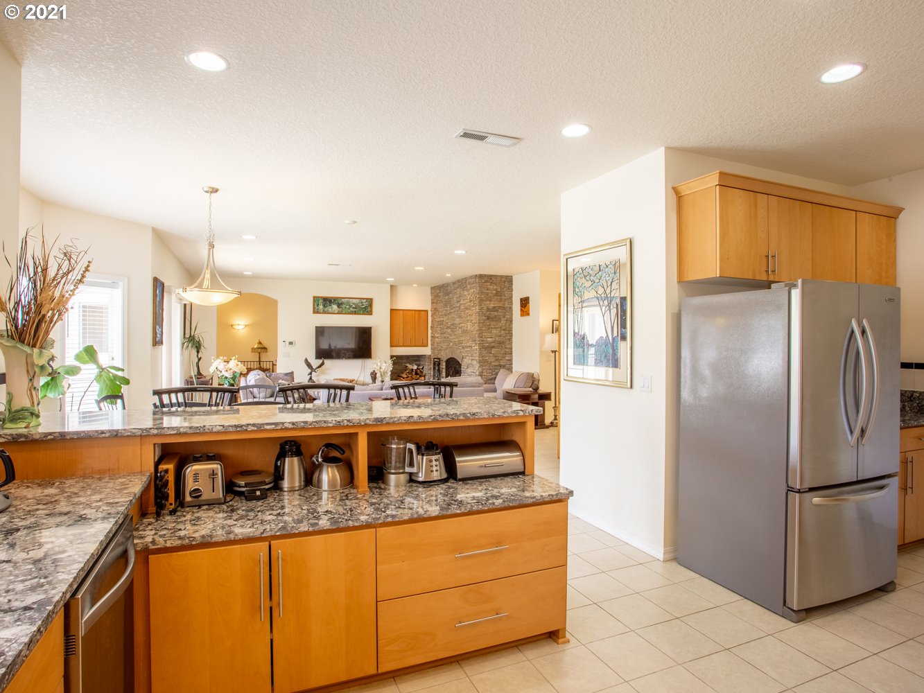 18509 Northeast Risto Road Battle Ground, WA 98604 - Photo 21 of 32 a view of a kitchen with kitchen island stainless steel appliances granite countertop a refrigerator and a sink