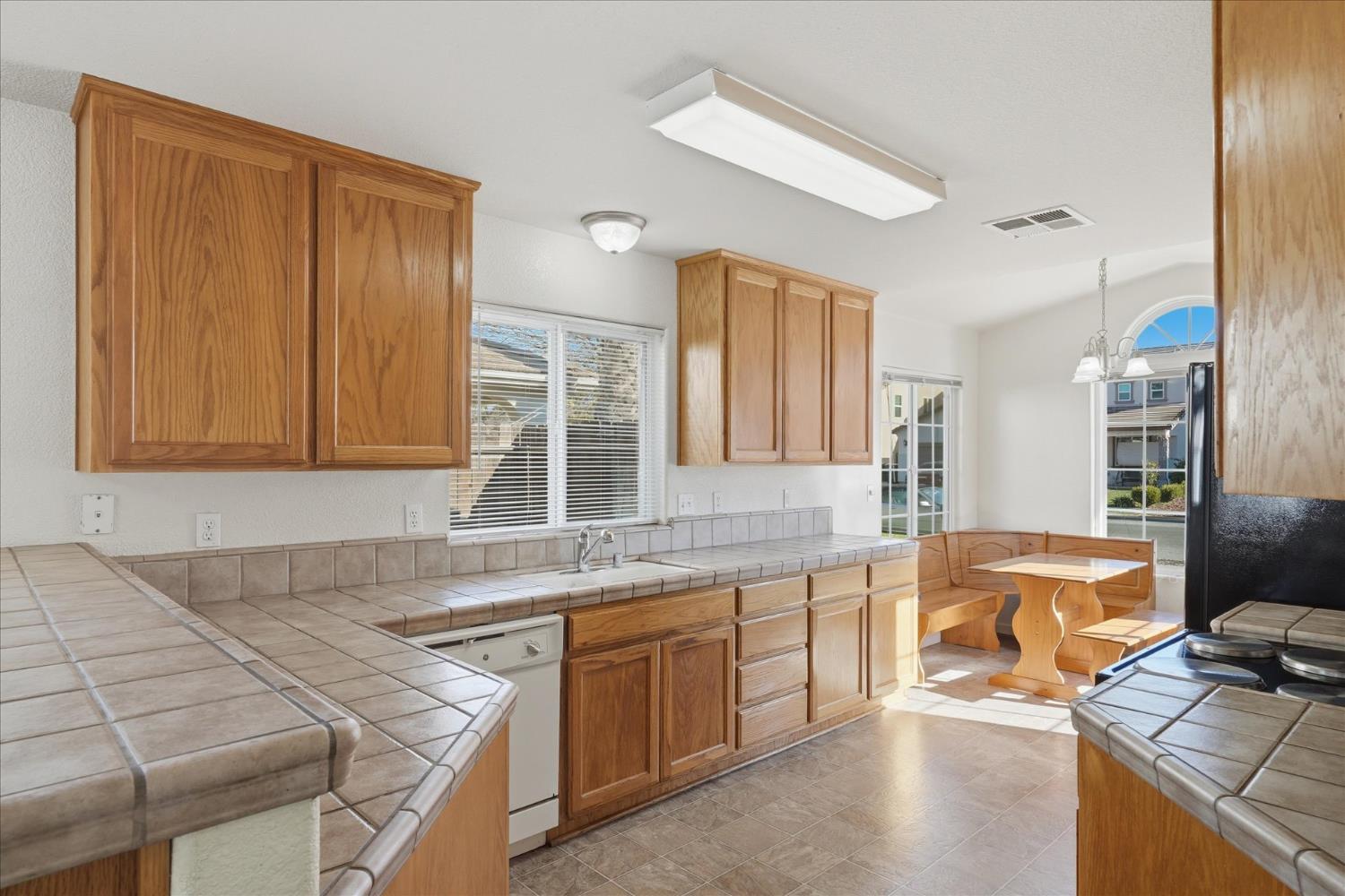 988 Monterey Street Madera, CA 93637 - Photo 11 of 36 a kitchen with a sink cabinets and window
