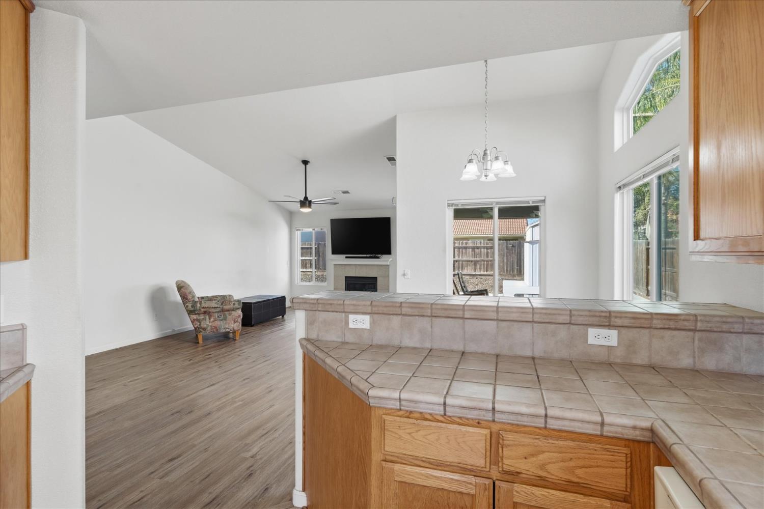988 Monterey Street Madera, CA 93637 - Photo 14 of 36 a kitchen with granite countertop a stove and cabinets