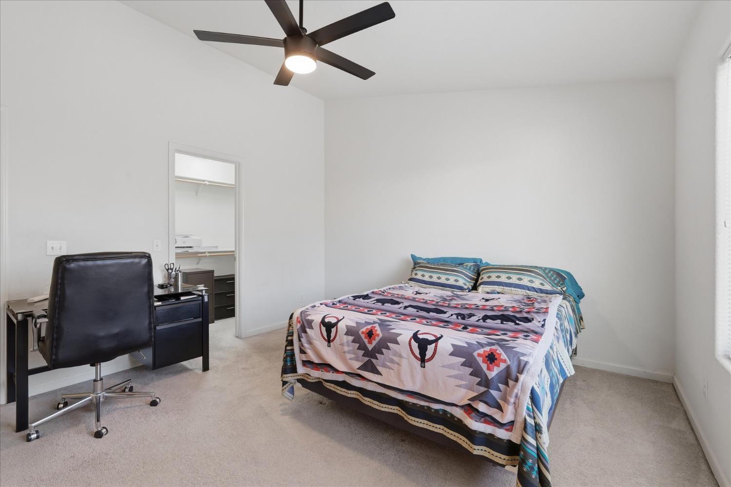 988 Monterey Street Madera, CA 93637 - Photo 16 of 36 a bedroom with a bed chair and a window