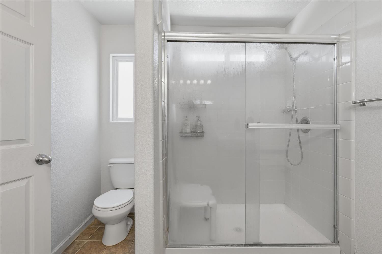 988 Monterey Street Madera, CA 93637 - Photo 20 of 36 a bathroom with a shower and a toilet