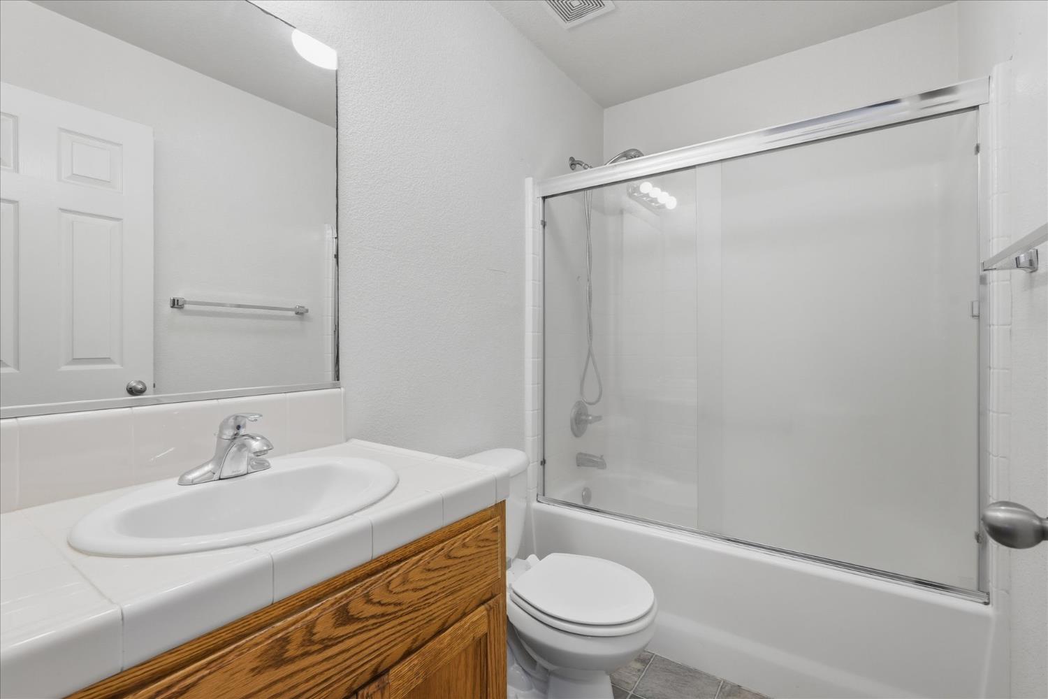 988 Monterey Street Madera, CA 93637 - Photo 22 of 36 a bathroom with a sink toilet and shower