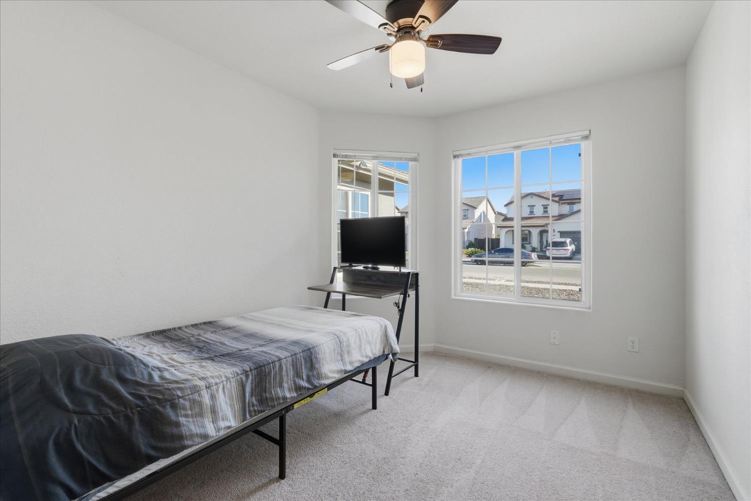 988 Monterey Street Madera, CA 93637 - Photo 26 of 36 a bedroom with a bed and a window