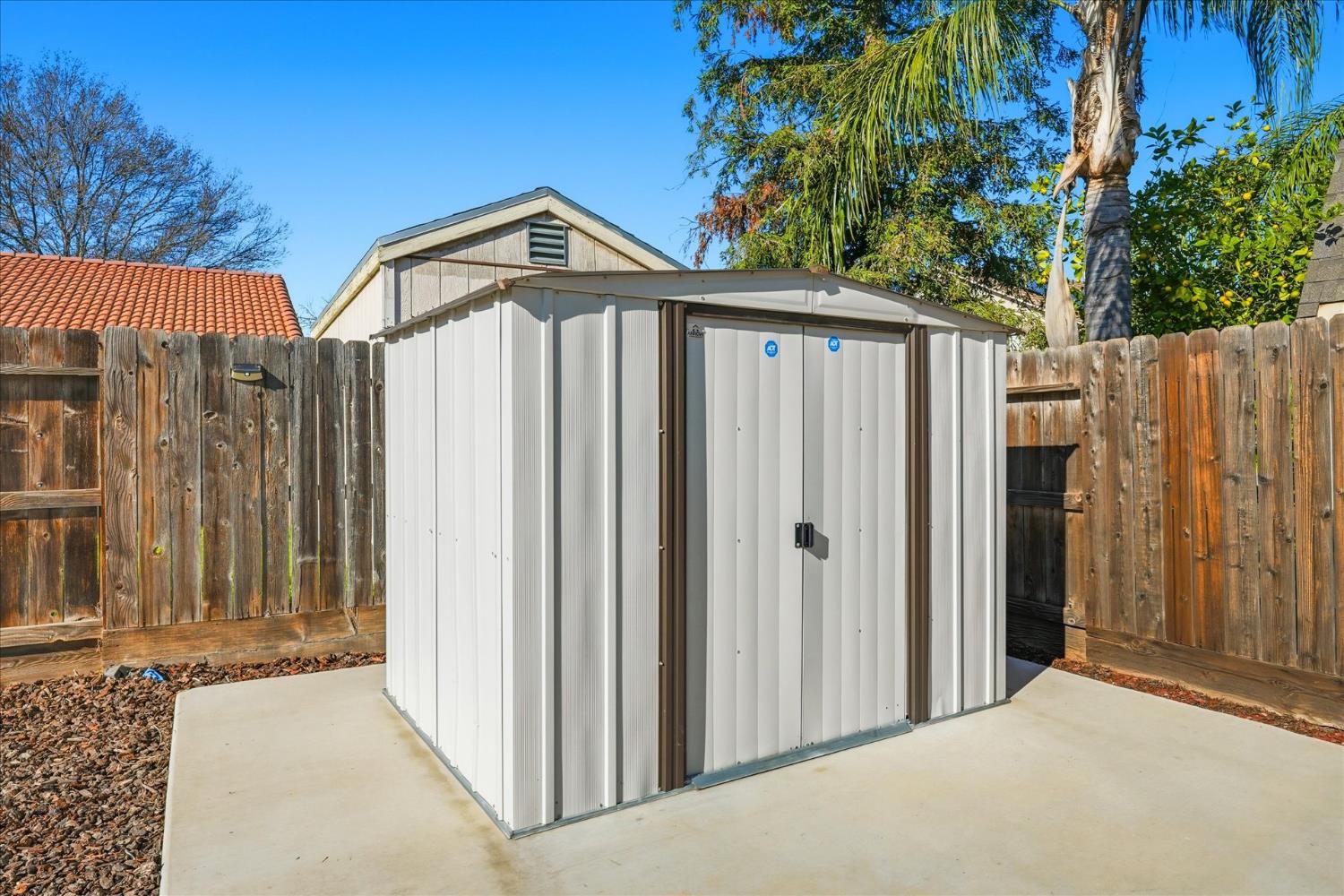 988 Monterey Street Madera, CA 93637 - Photo 31 of 36 a view of a house with a backyard and trees