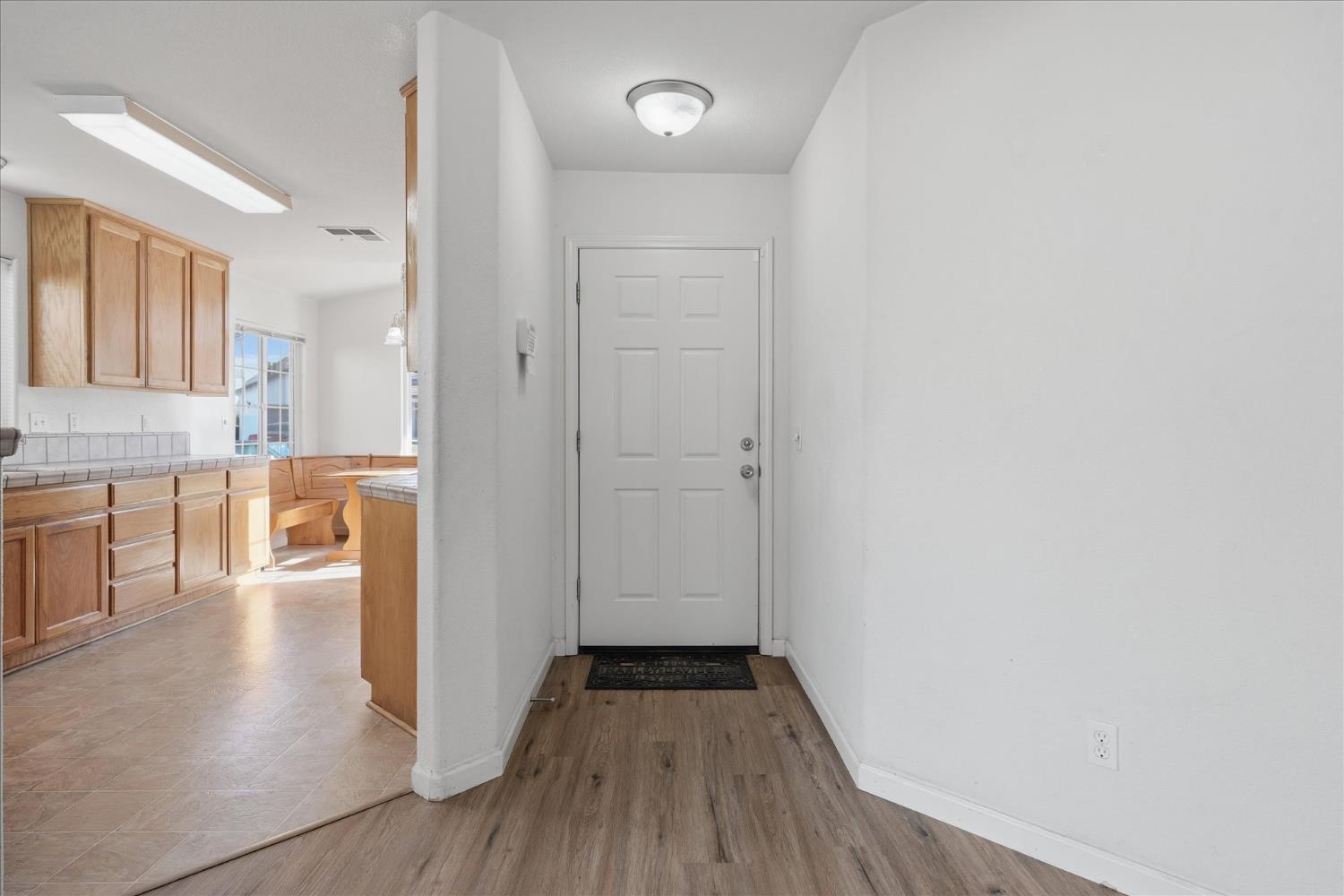 988 Monterey Street Madera, CA 93637 - Photo 4 of 36 a view of a hallway with wooden floor