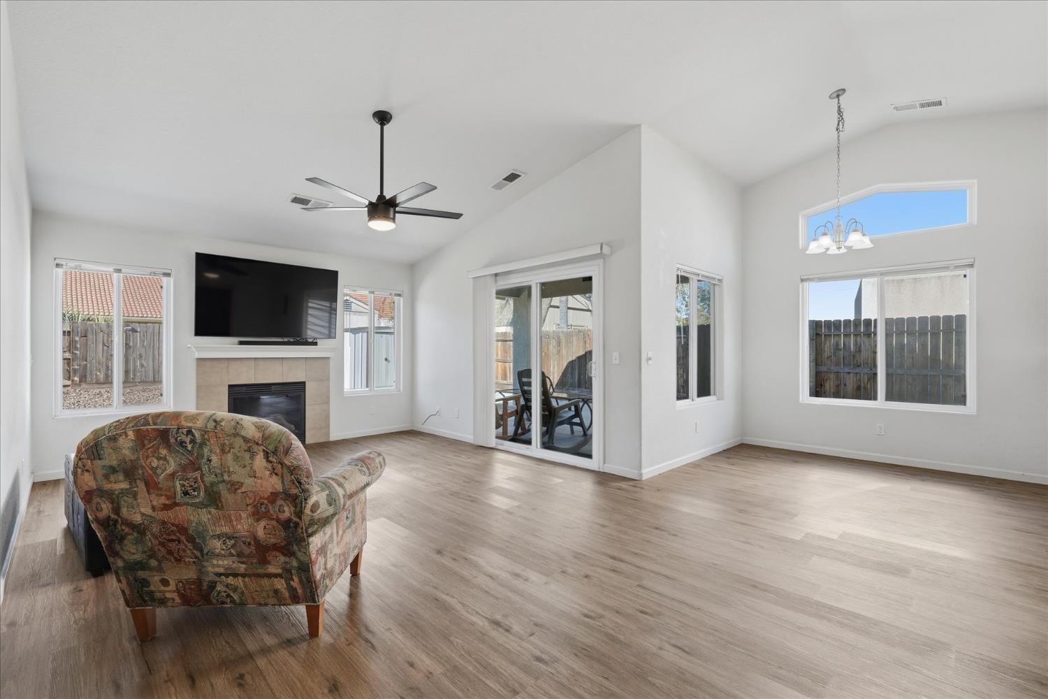 988 Monterey Street Madera, CA 93637 - Photo 6 of 36 a view of a livingroom with wooden floor and a fireplace