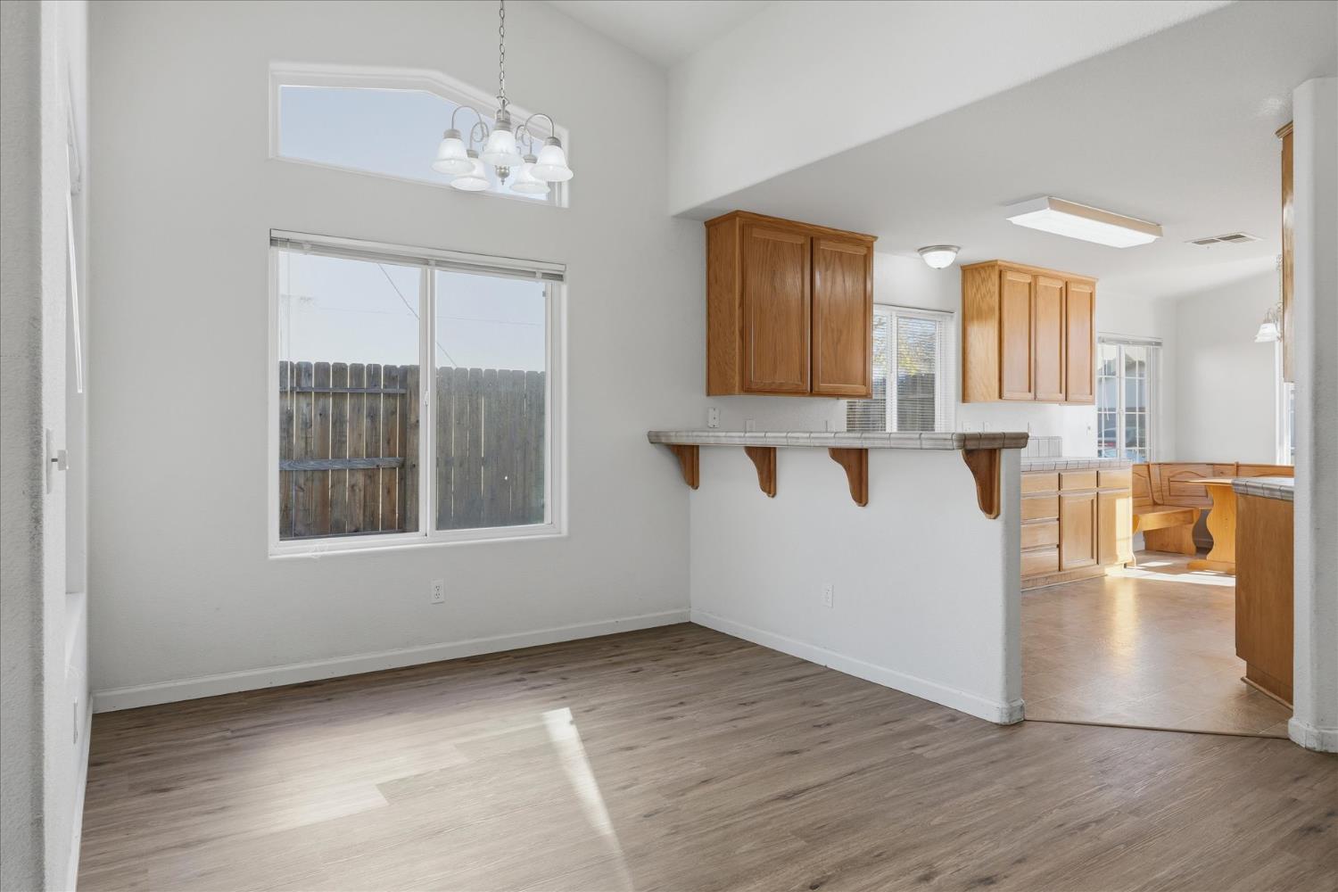 988 Monterey Street Madera, CA 93637 - Photo 9 of 36 a view of a kitchen with furniture and wooden floor