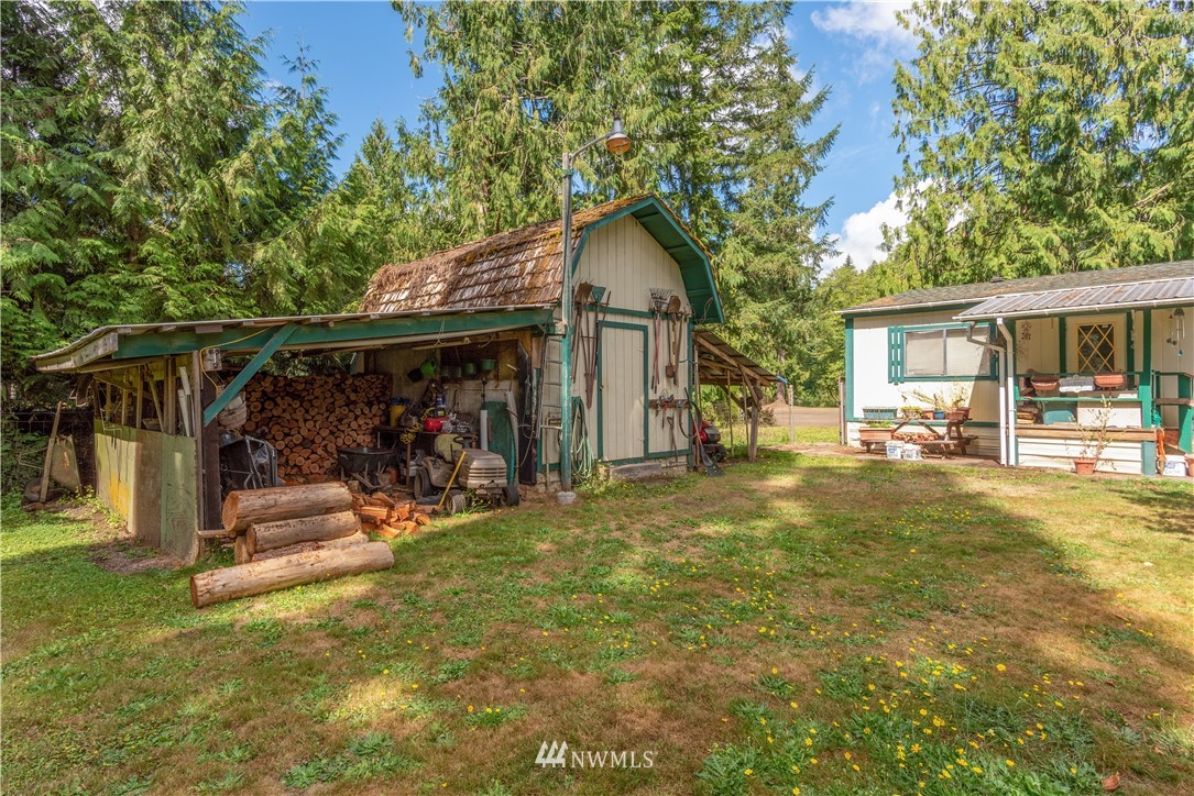 115 Island Road Toledo, WA 98591 - Photo 16 of 22 a view of a house with a backyard and a tree