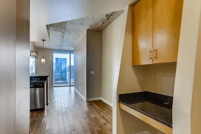 a kitchen with granite countertop a refrigerator and a stove top oven