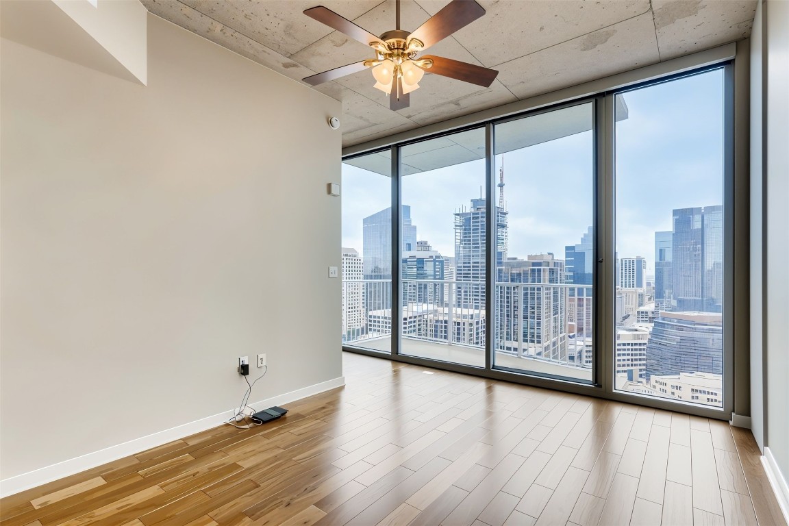 360 Nueces Street, Unit 2607 Austin, TX 78701 - Photo 12 of 23 a view of empty room with wooden floor and fan