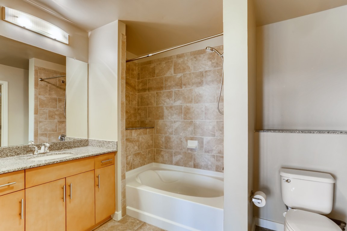360 Nueces Street, Unit 2607 Austin, TX 78701 - Photo 17 of 23 a bathroom with a granite countertop sink toilet and shower